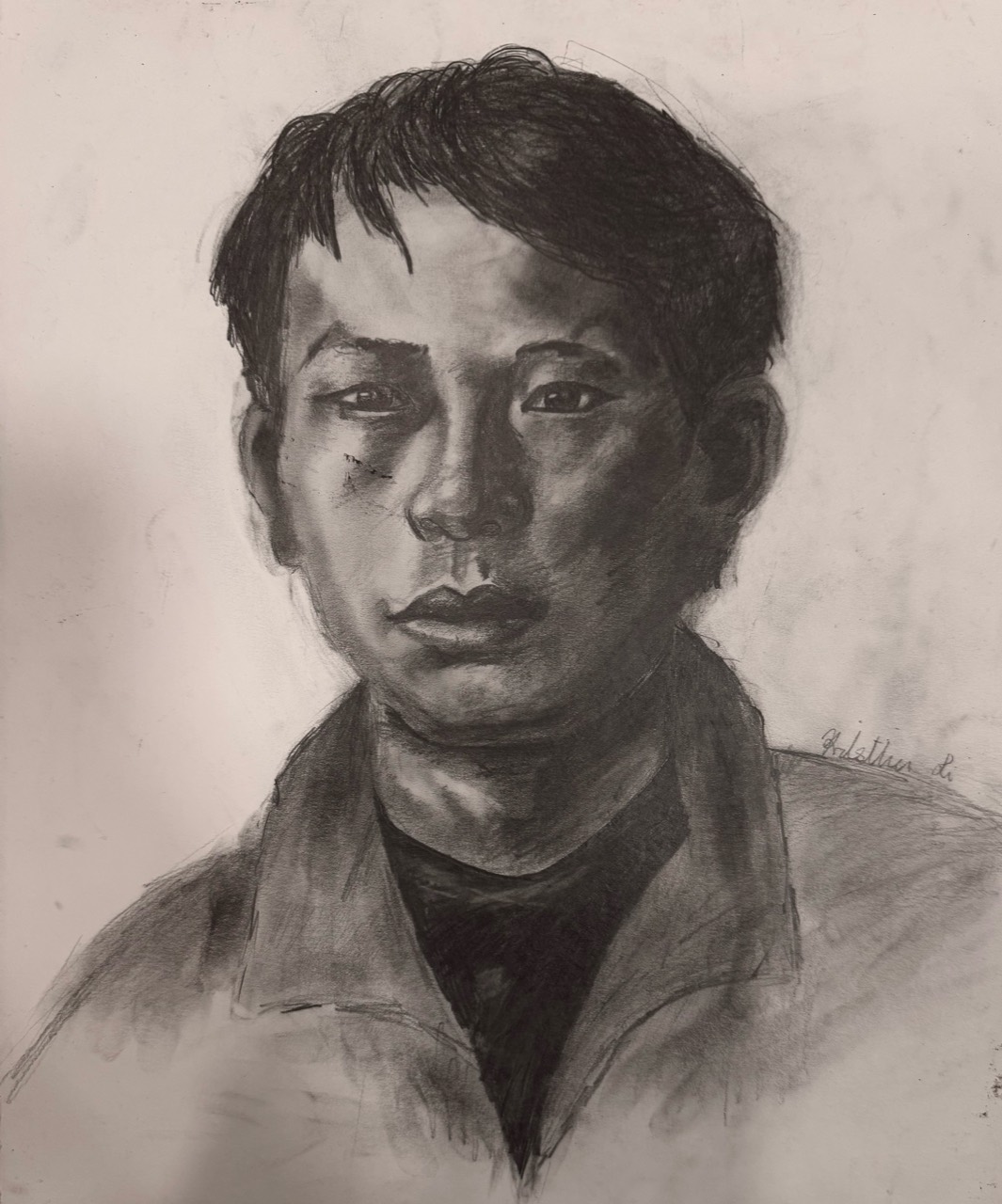 Graphite portrait of a young man facing forward