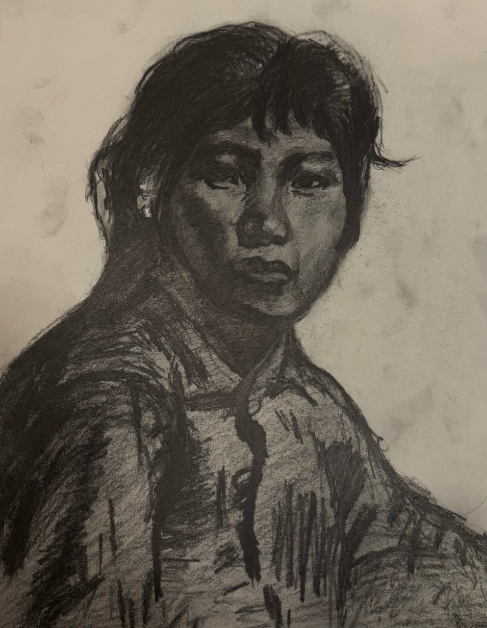 Graphite portrait of a person turning over one shoulder