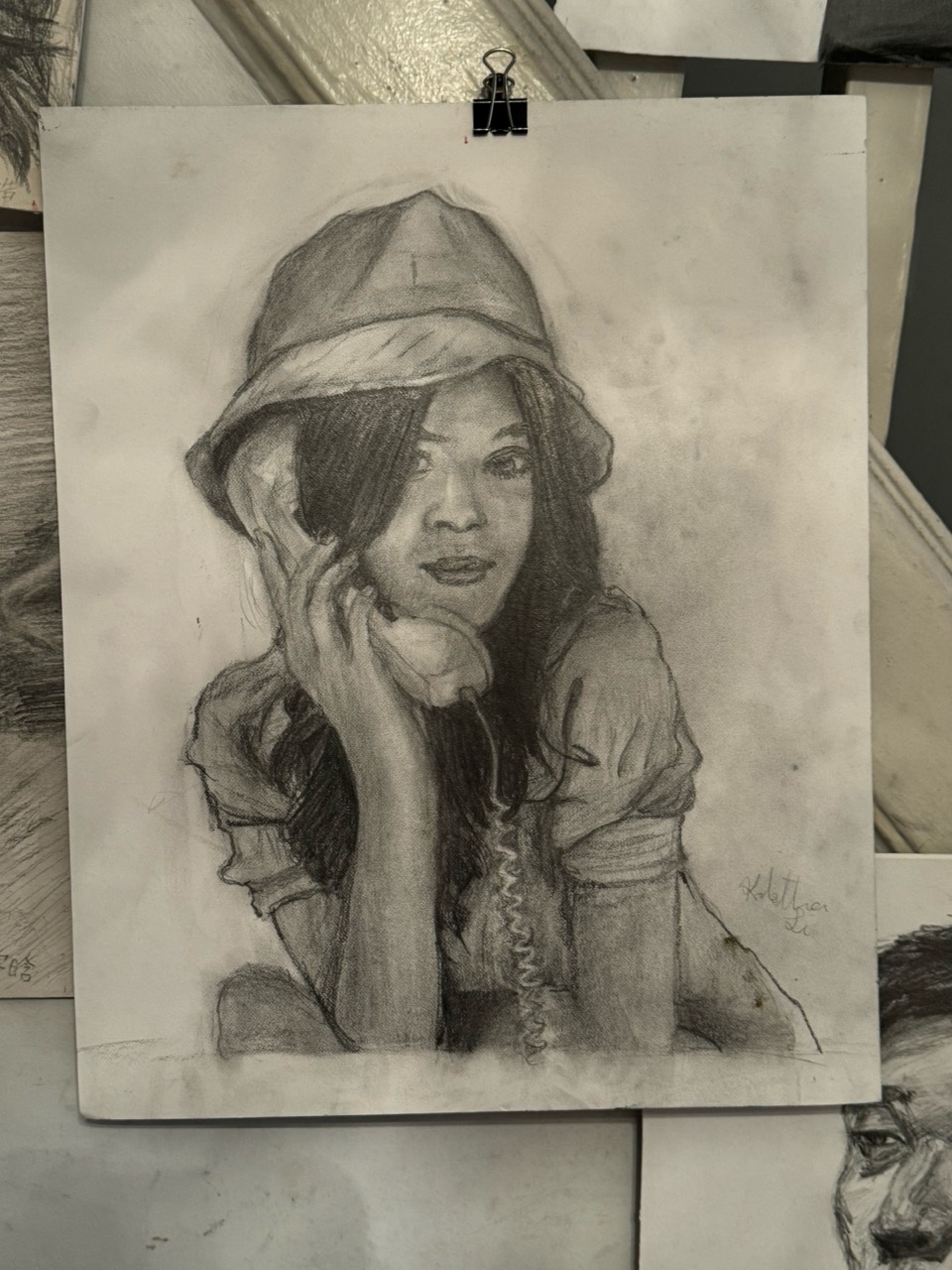 Graphite figure study of a woman holding a telephone