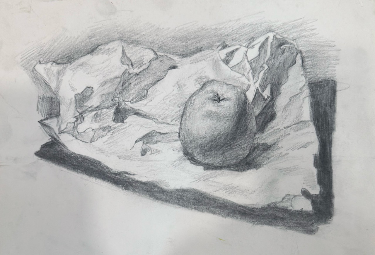 Graphite study of an apple resting on crumpled paper